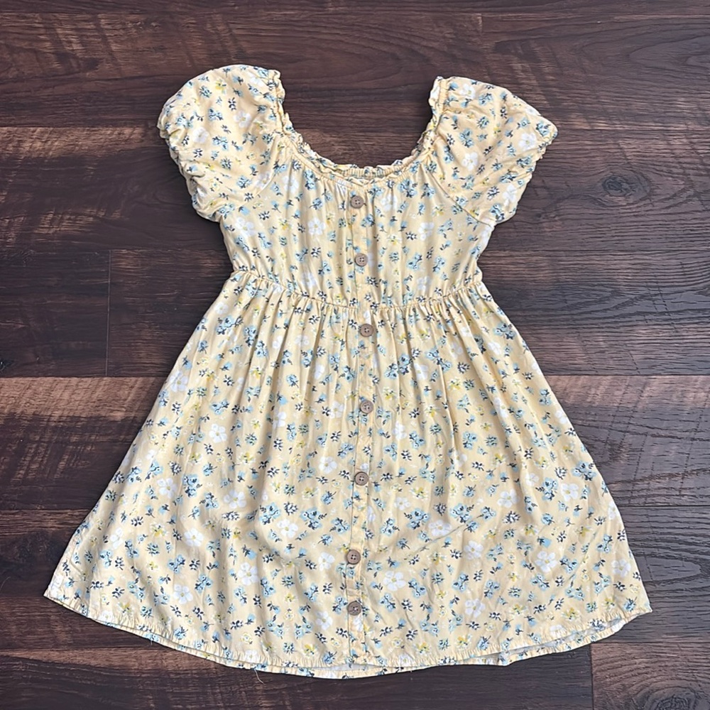 yellow dress with white and blue flowers
